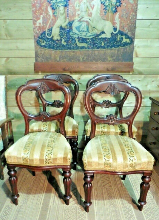 A Set Of Four Antique Carved Mahogany Balloon Back Dining Chairs