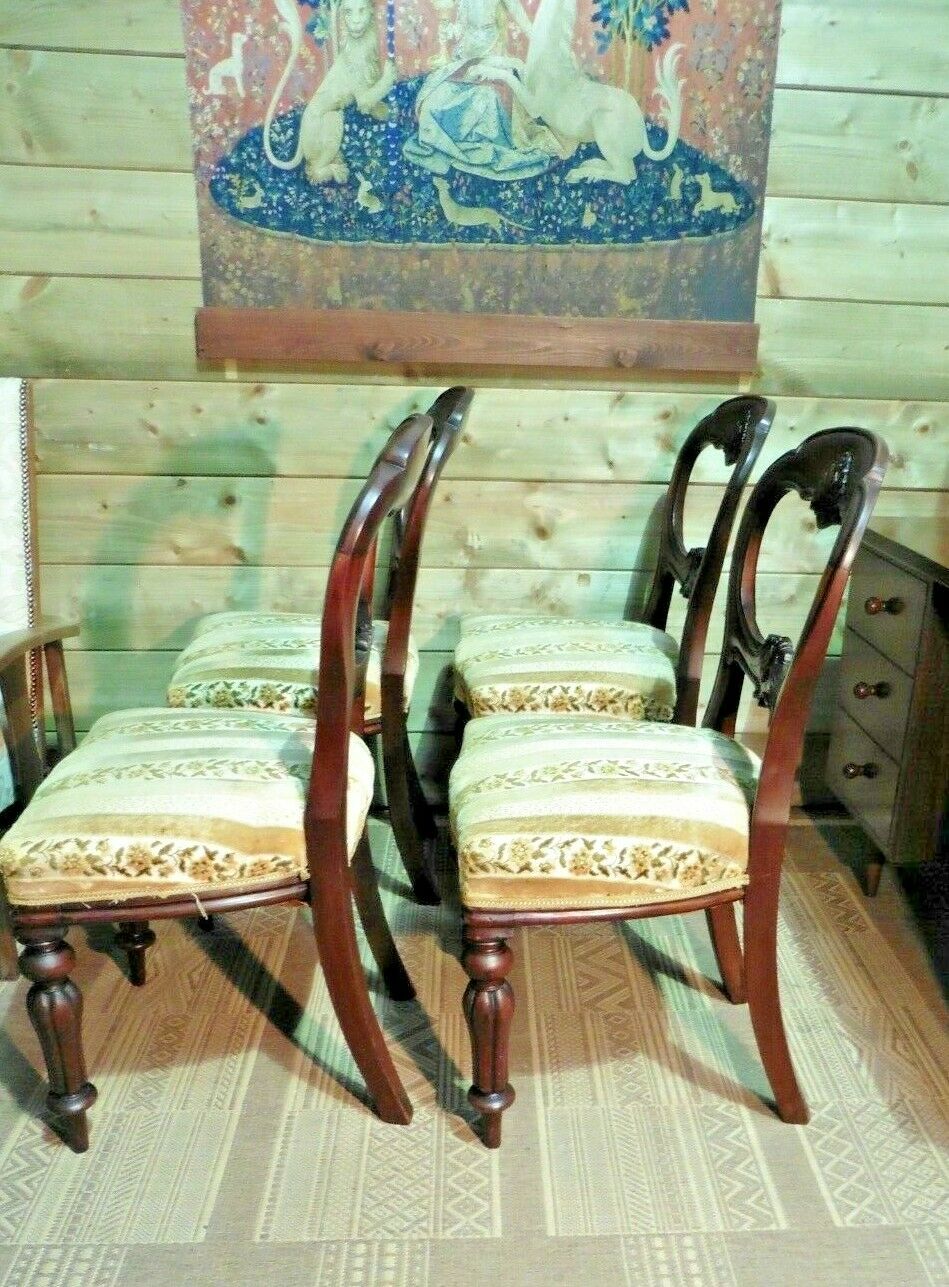 A Set Of Four Antique Carved Mahogany Balloon Back Dining Chairs