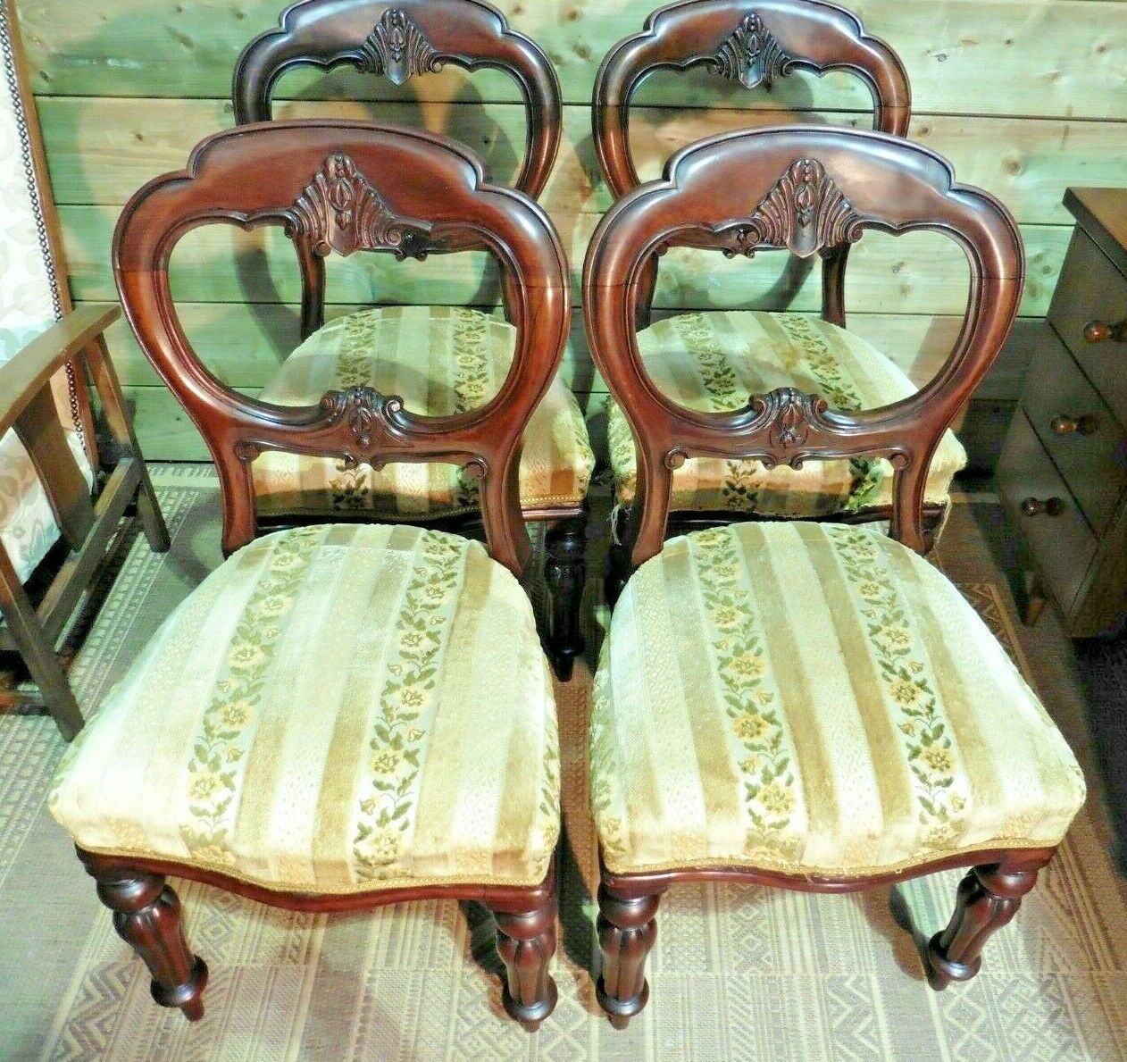 A Set Of Four Antique Carved Mahogany Balloon Back Dining Chairs